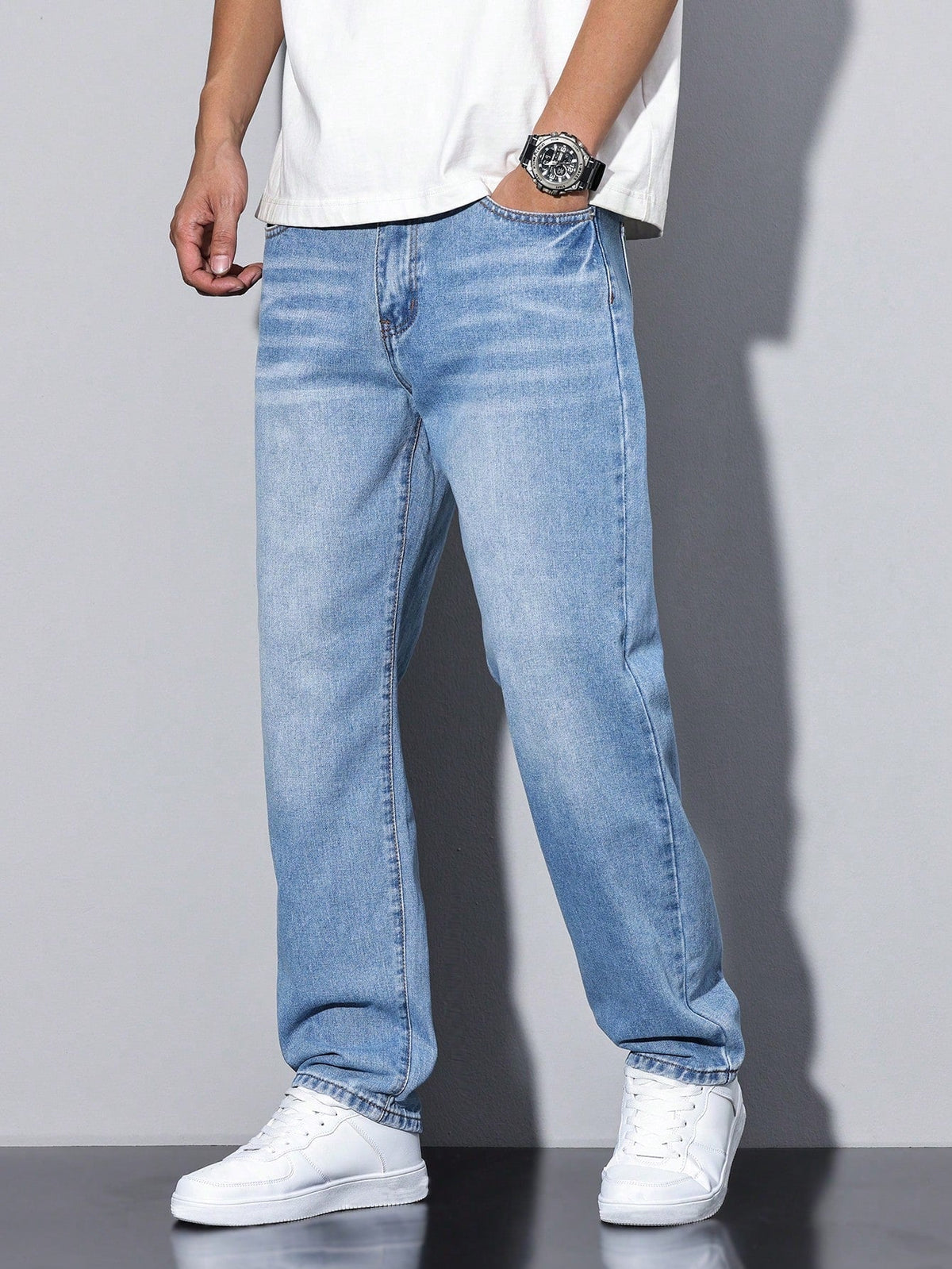Men's loose straight leg jeans shown in grey and blue denim washes