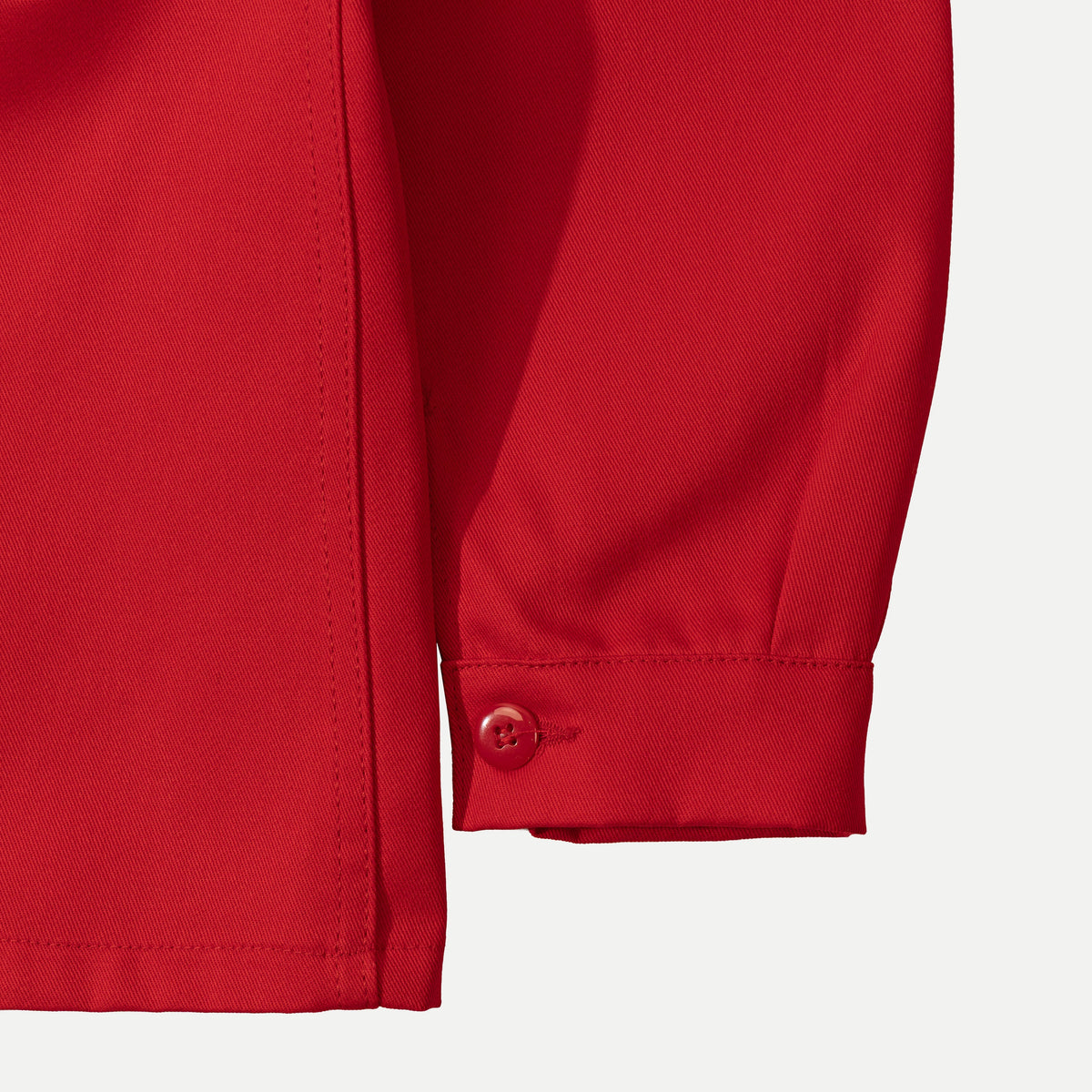 Men's red long-sleeve chore jacket with button front and three patch pockets