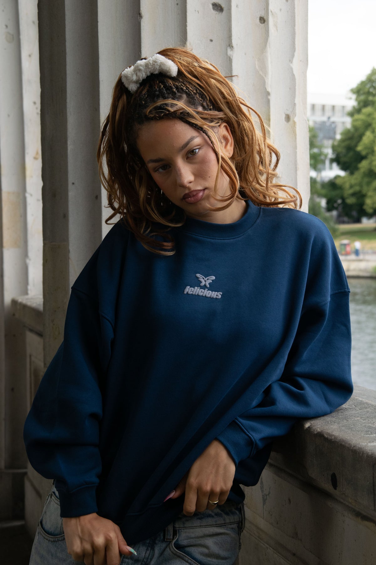 Navy crewneck sweatshirt with raised chest logo and ribbed trims