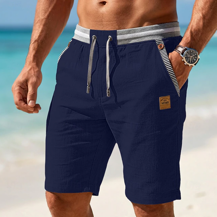 Men's drawstring shorts in light blue with textured weave, knee length, side pockets and branded patch detail