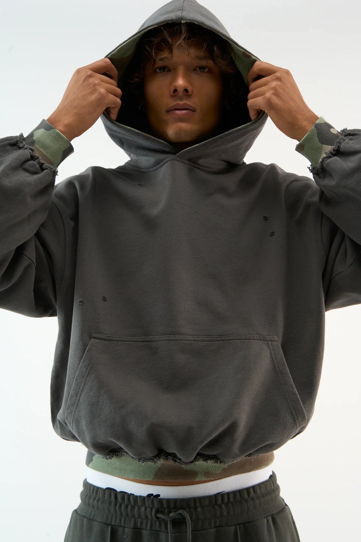 Distressed camouflage hoodie with hood, long sleeves and front pouch pocket