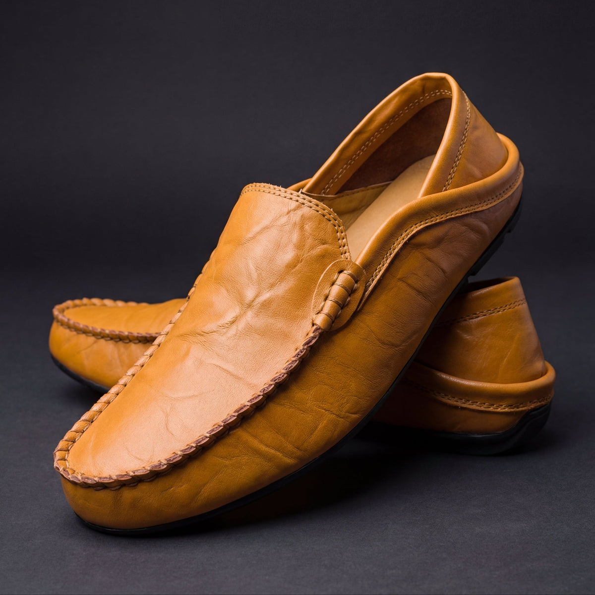 Unisex moc-toe loafers with stitched trim and flat soles