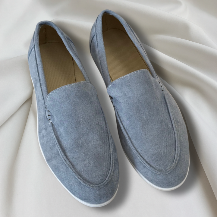 Black and navy suede loafers with cream sole and moc-toe stitching