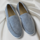 Black and navy suede loafers with cream sole and moc-toe stitching