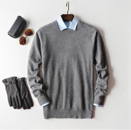 Solid crew neck sweater with long sleeves and ribbed trims layered over a collared shirt