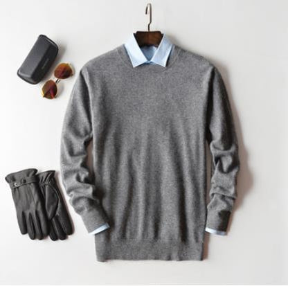 Solid crew neck sweater with long sleeves and ribbed trims layered over a collared shirt