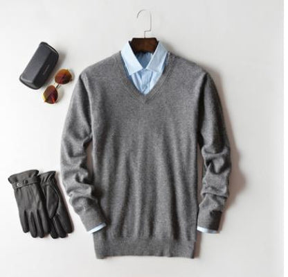 Solid crew neck sweater with long sleeves and ribbed trims layered over a collared shirt