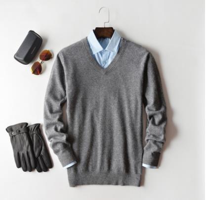 Solid crew neck sweater with long sleeves and ribbed trims layered over a collared shirt