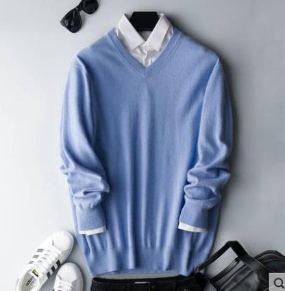 Solid crew neck sweater with long sleeves and ribbed trims layered over a collared shirt