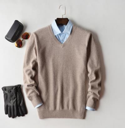 Solid crew neck sweater with long sleeves and ribbed trims layered over a collared shirt