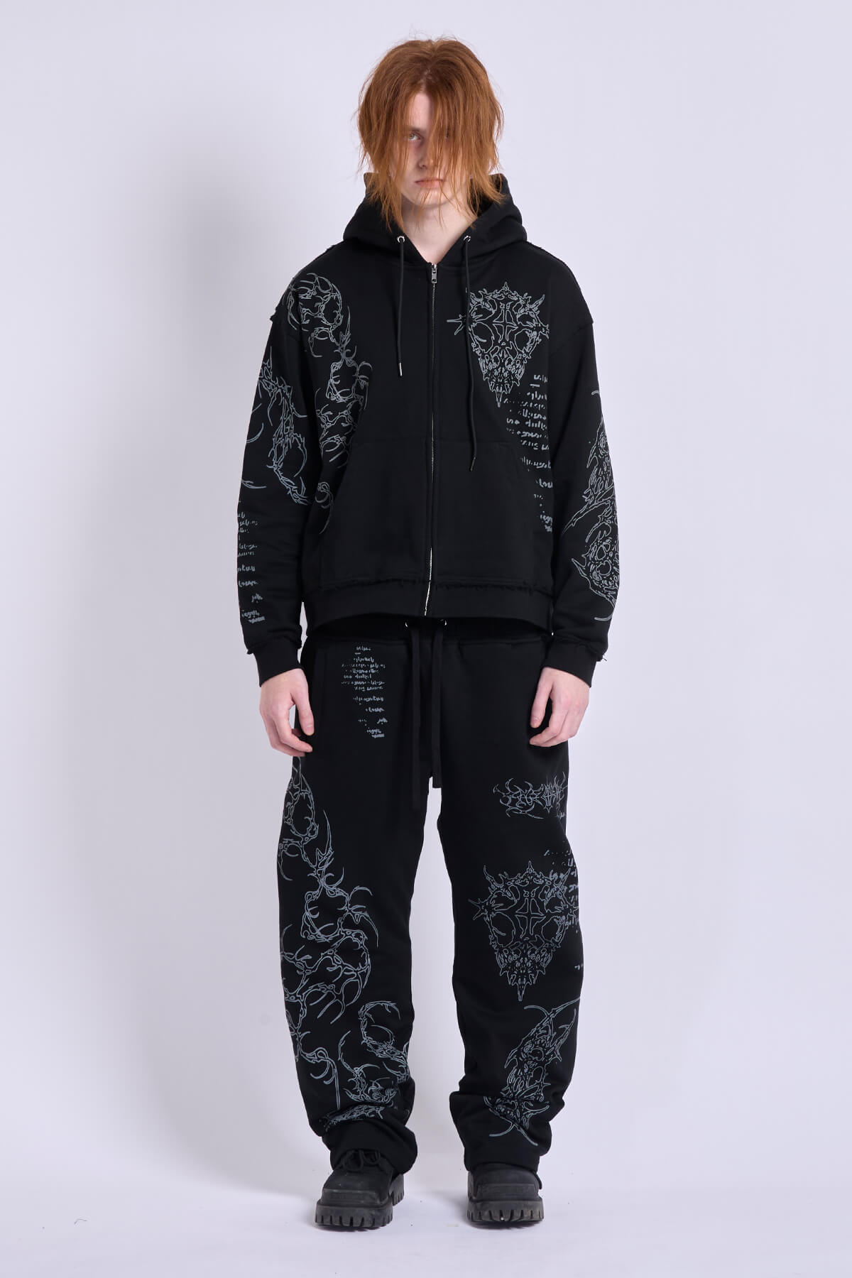 Black unisex zip hoodie with hood, long sleeves and contrasting graphic prints