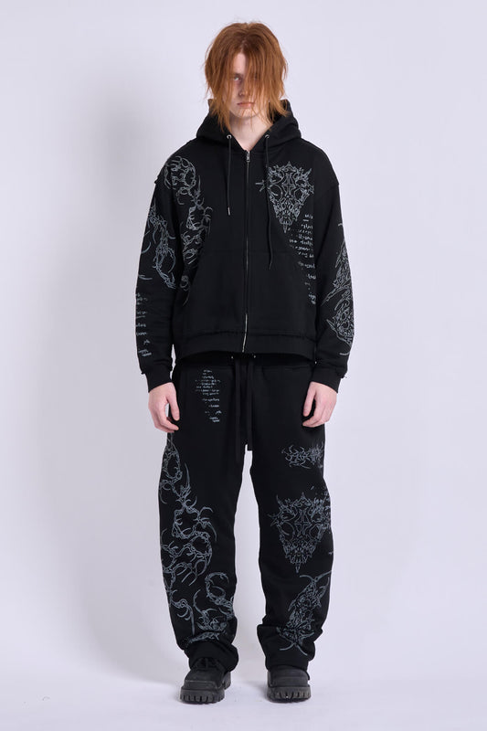 Black unisex zip hoodie with hood, long sleeves and contrasting graphic prints