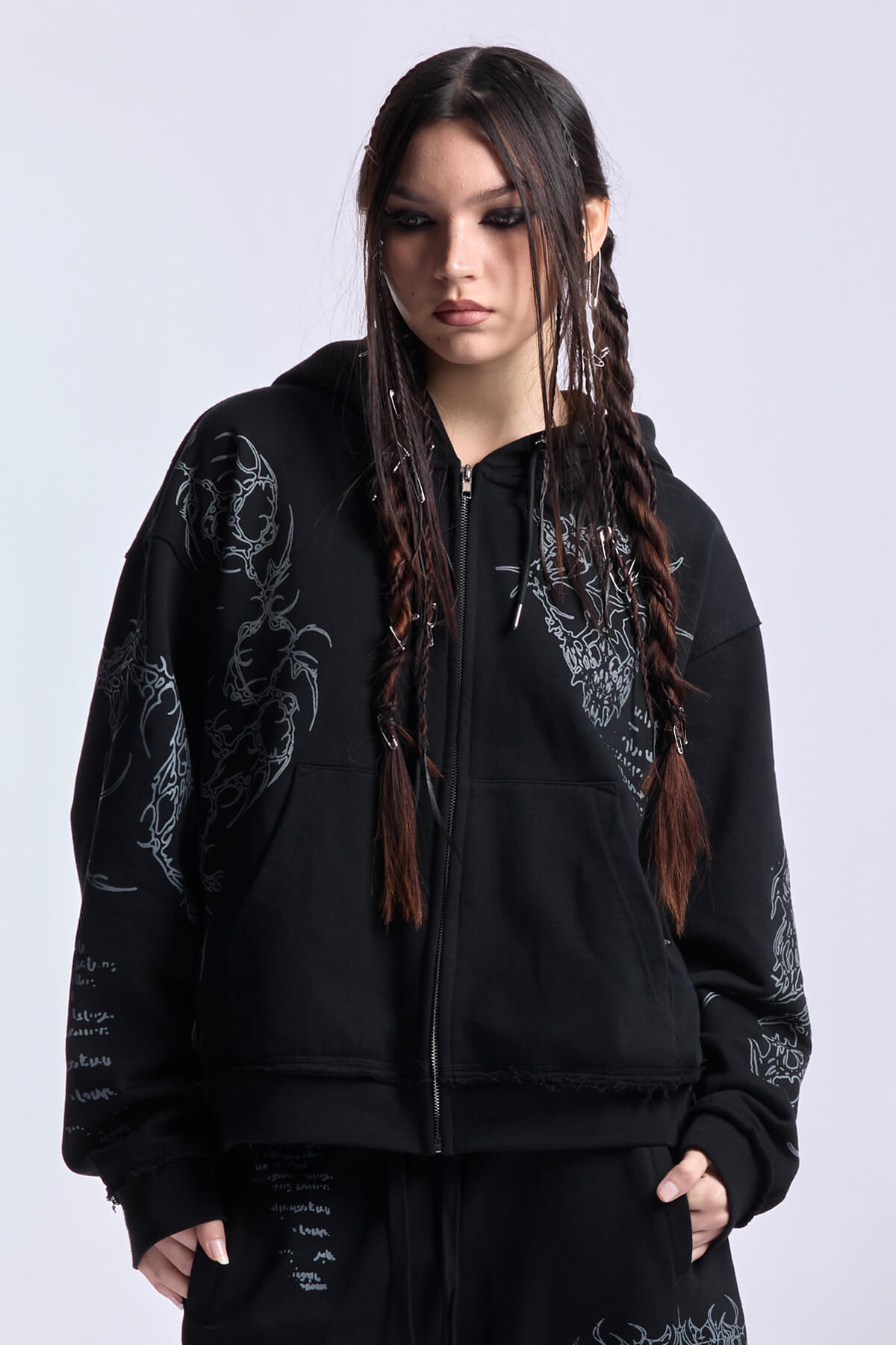 Black unisex zip hoodie with hood, long sleeves and contrasting graphic prints