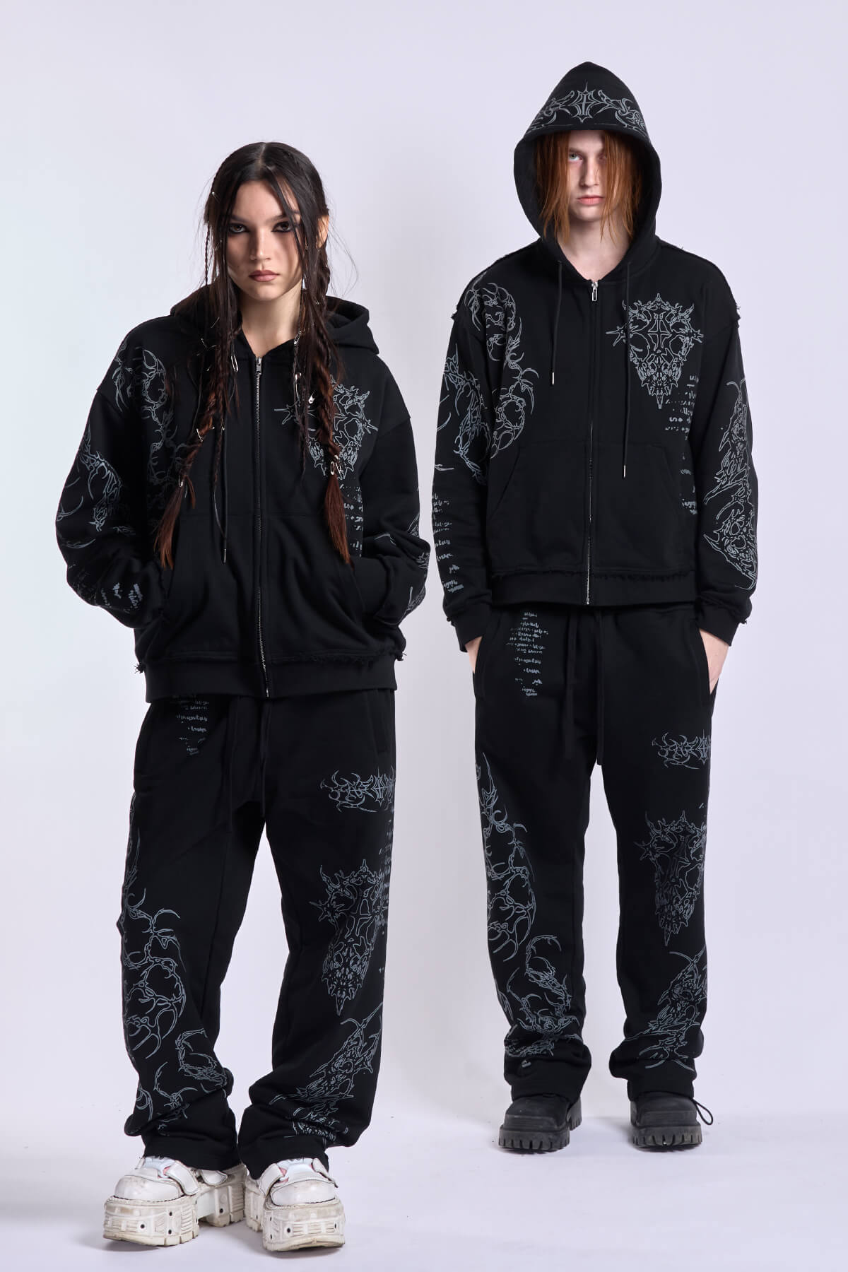 Black unisex zip hoodie with hood, long sleeves and contrasting graphic prints