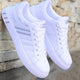 Men's lace-up sneakers with striped side details and flat soles