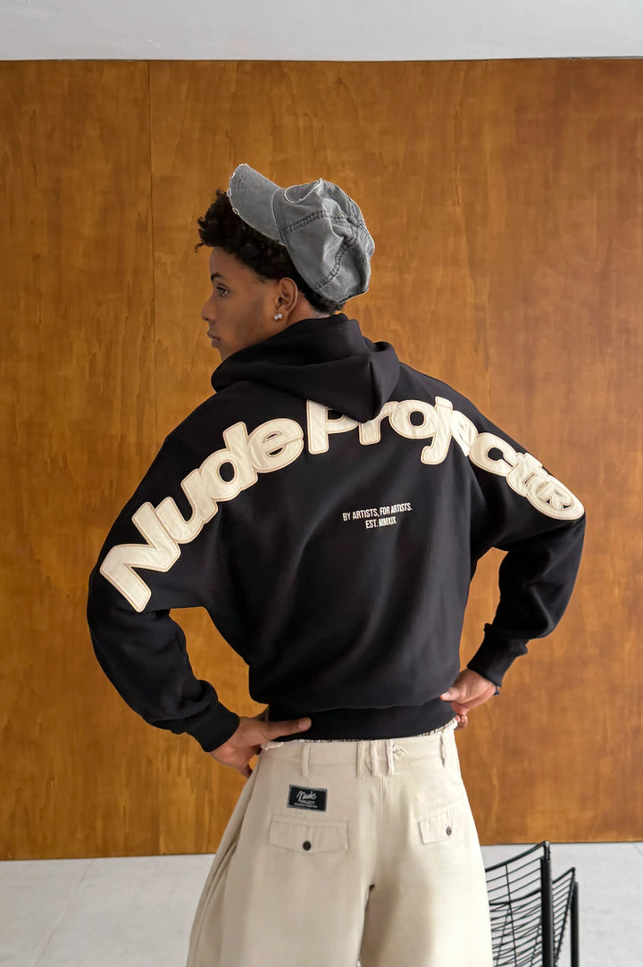 Black zip-up hoodie with hood and cream graphic on the back