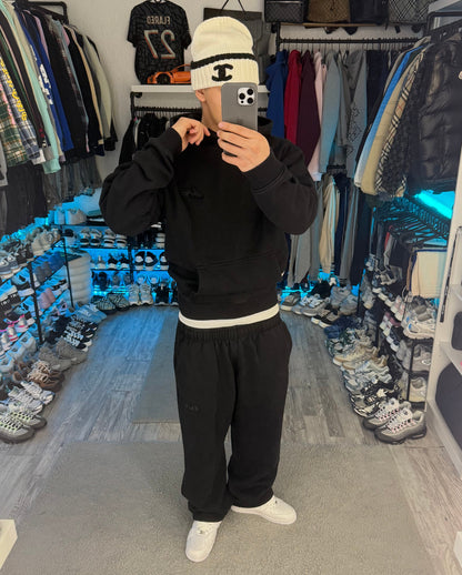 Black pullover hoodie with hood, long sleeves and front pouch pocket
