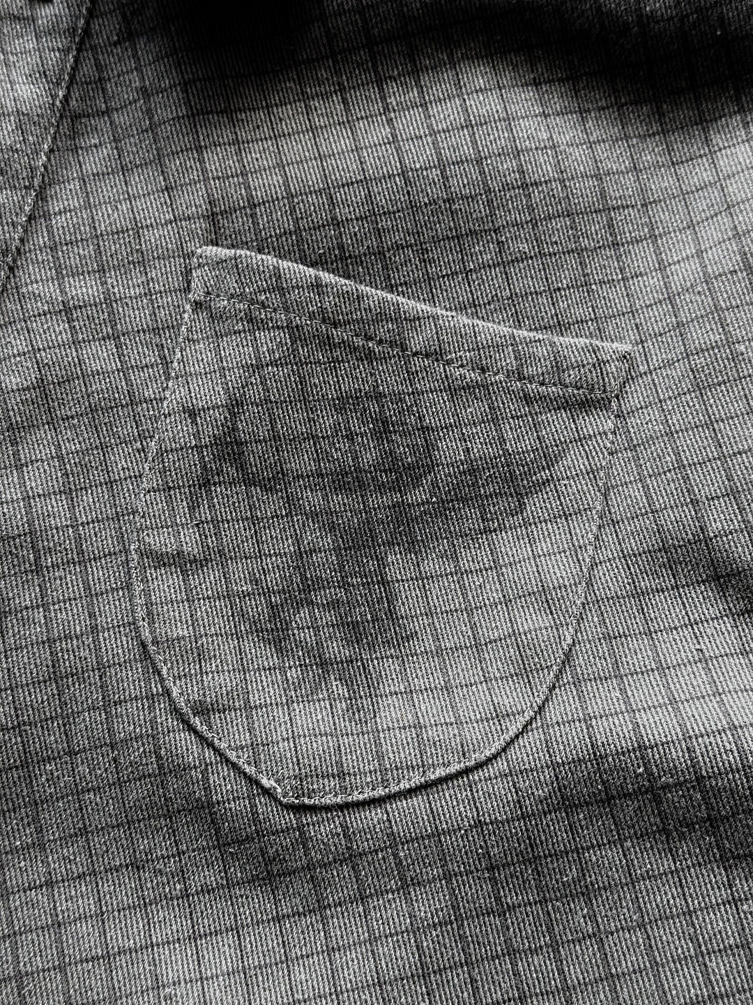 Gray checkered graphic shirt with buttons, chest pocket and frayed edges