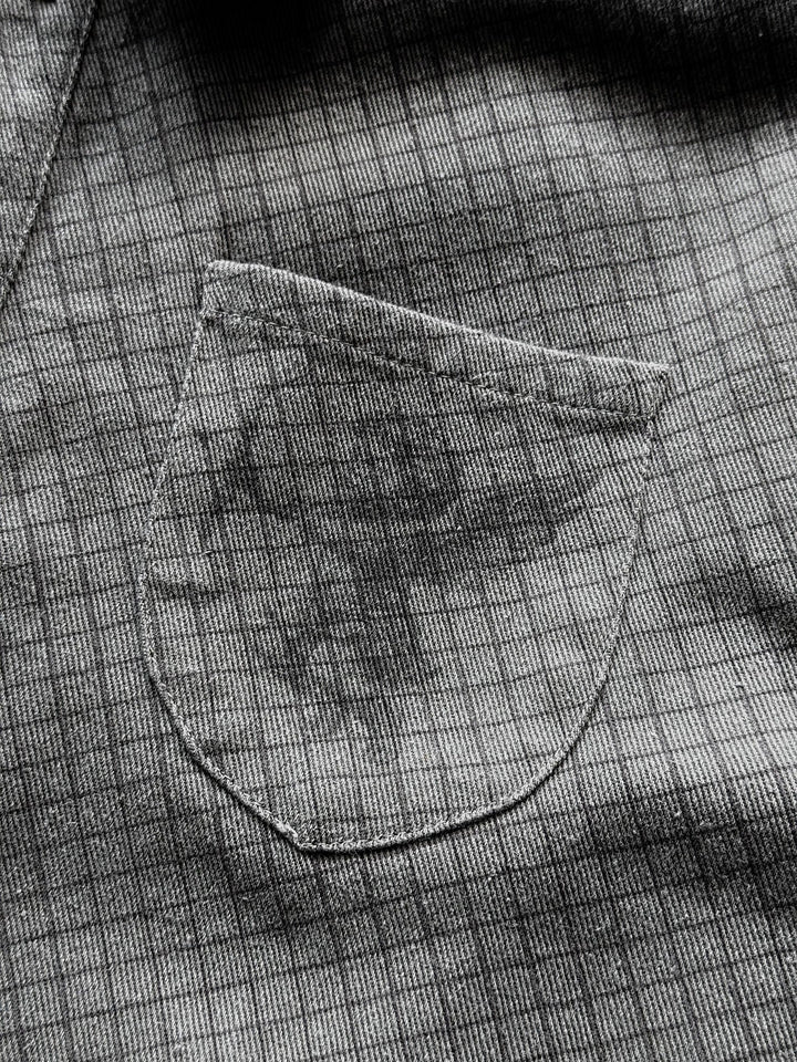 Gray checkered graphic shirt with buttons, chest pocket and frayed edges