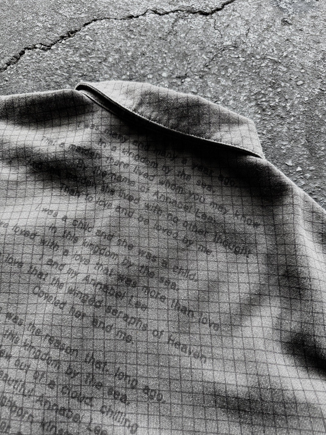 Gray checkered graphic shirt with buttons, chest pocket and frayed edges