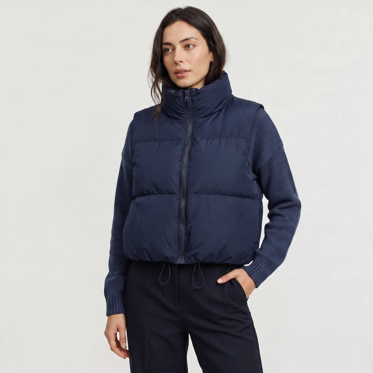 Women's cropped padded gilet with hooded collar, front zip and adjustable hem