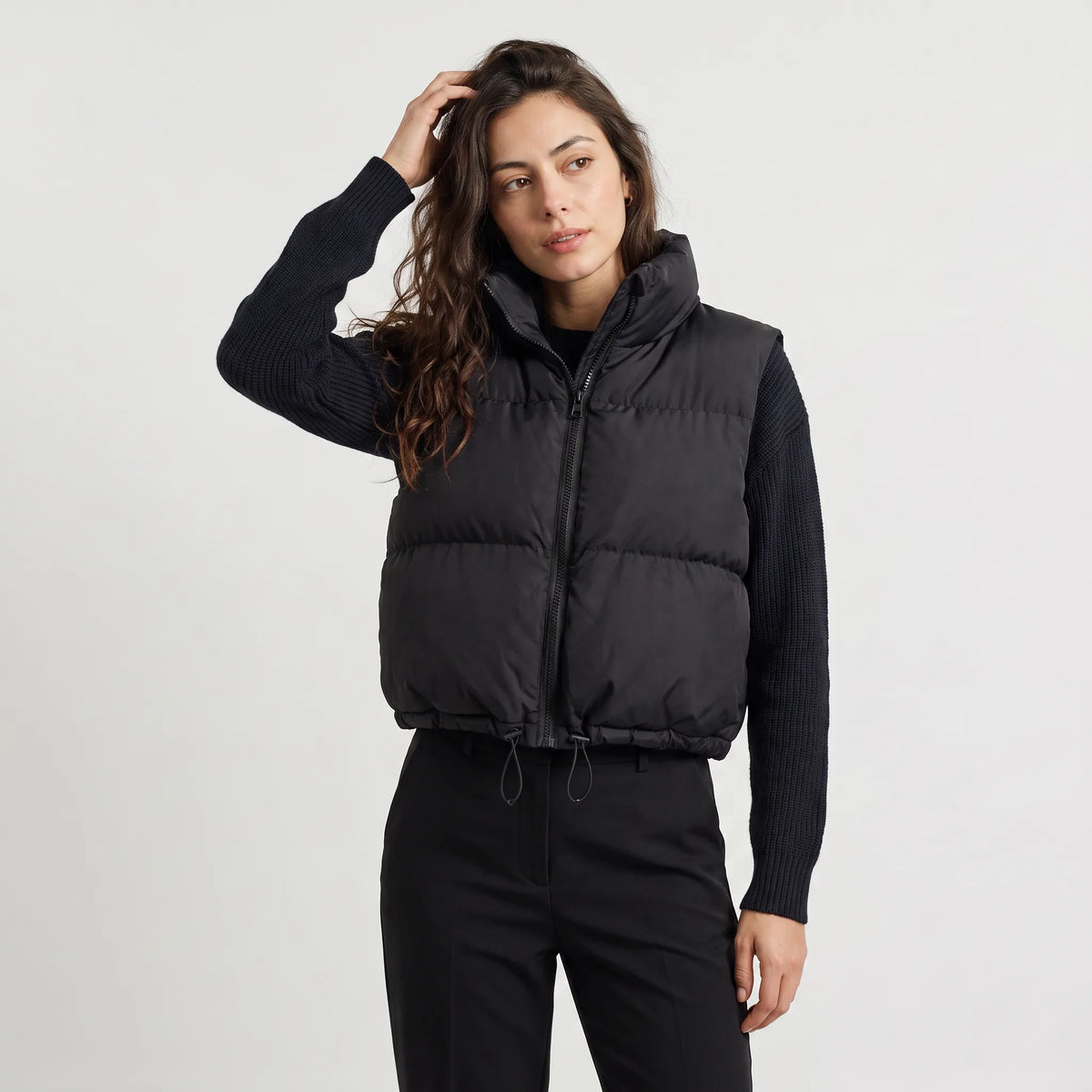 Women's cropped padded gilet with hooded collar, front zip and adjustable hem