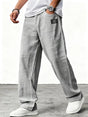 Man wearing blue wide leg relaxed fit trousers with white sneakers