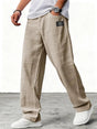 Man wearing blue wide leg relaxed fit trousers with white sneakers