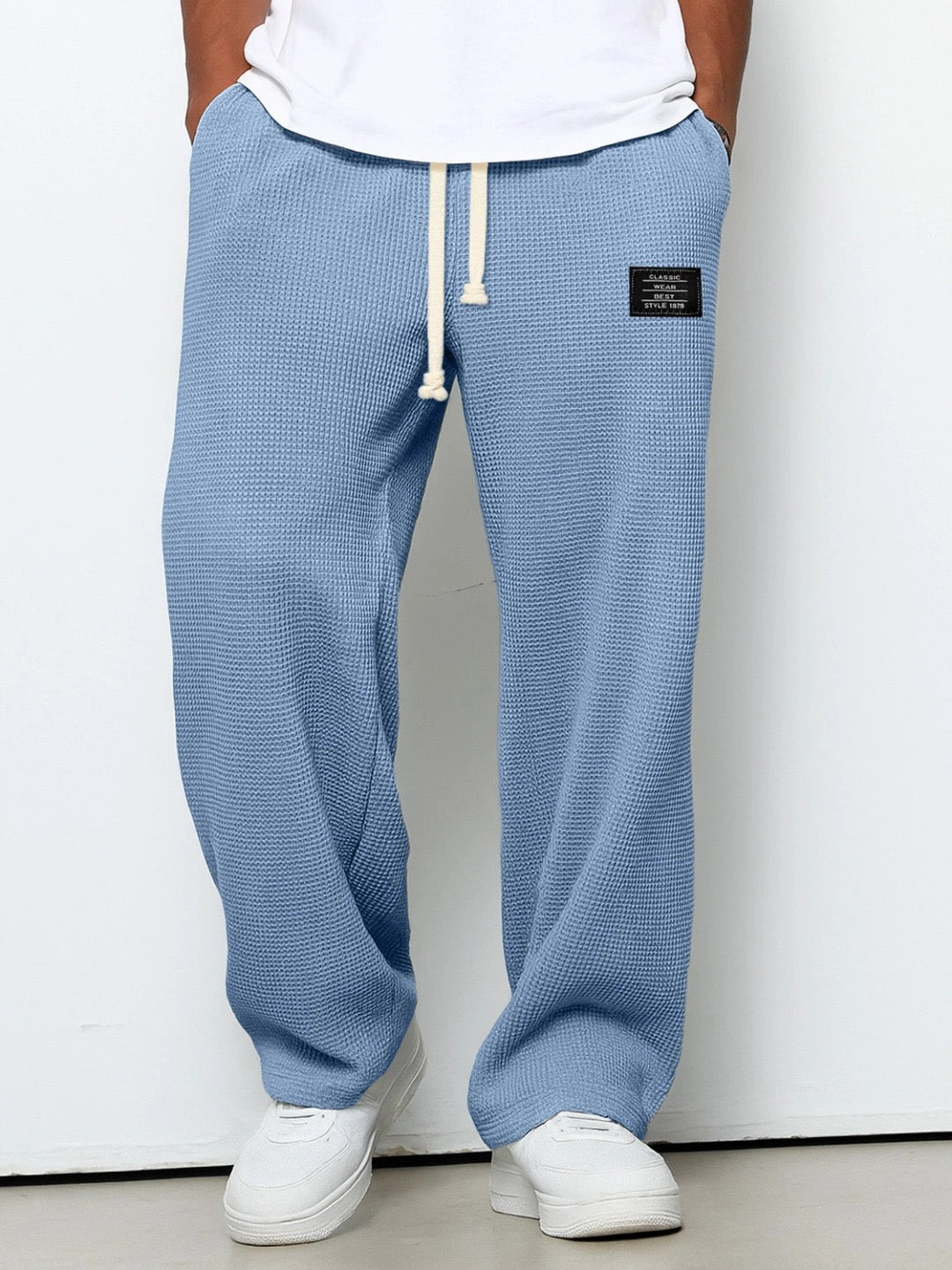 Men's wide leg textured trousers with drawstring waist, shown in blue and cream variants