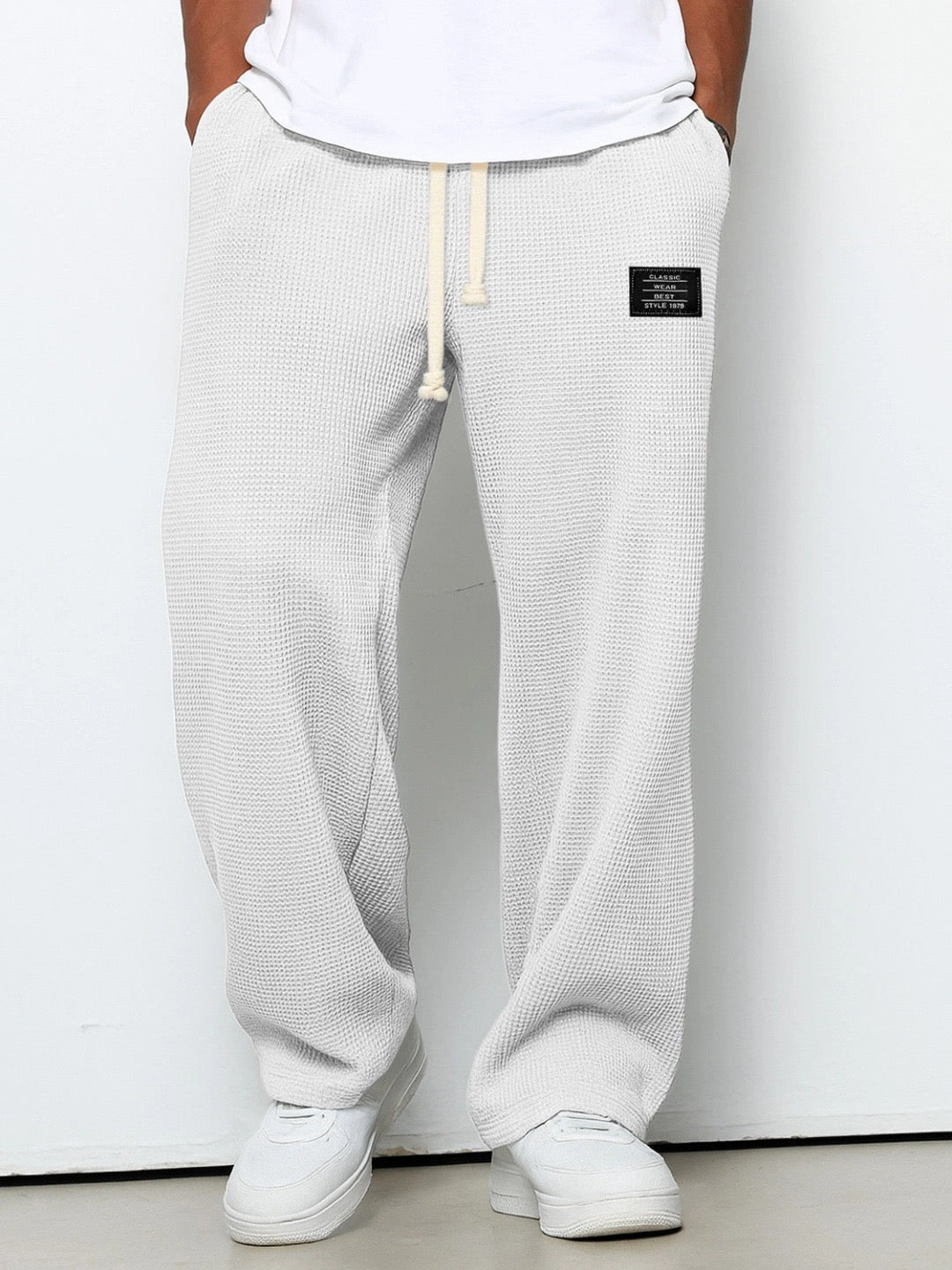 Men's wide leg textured trousers with drawstring waist, shown in blue and cream variants
