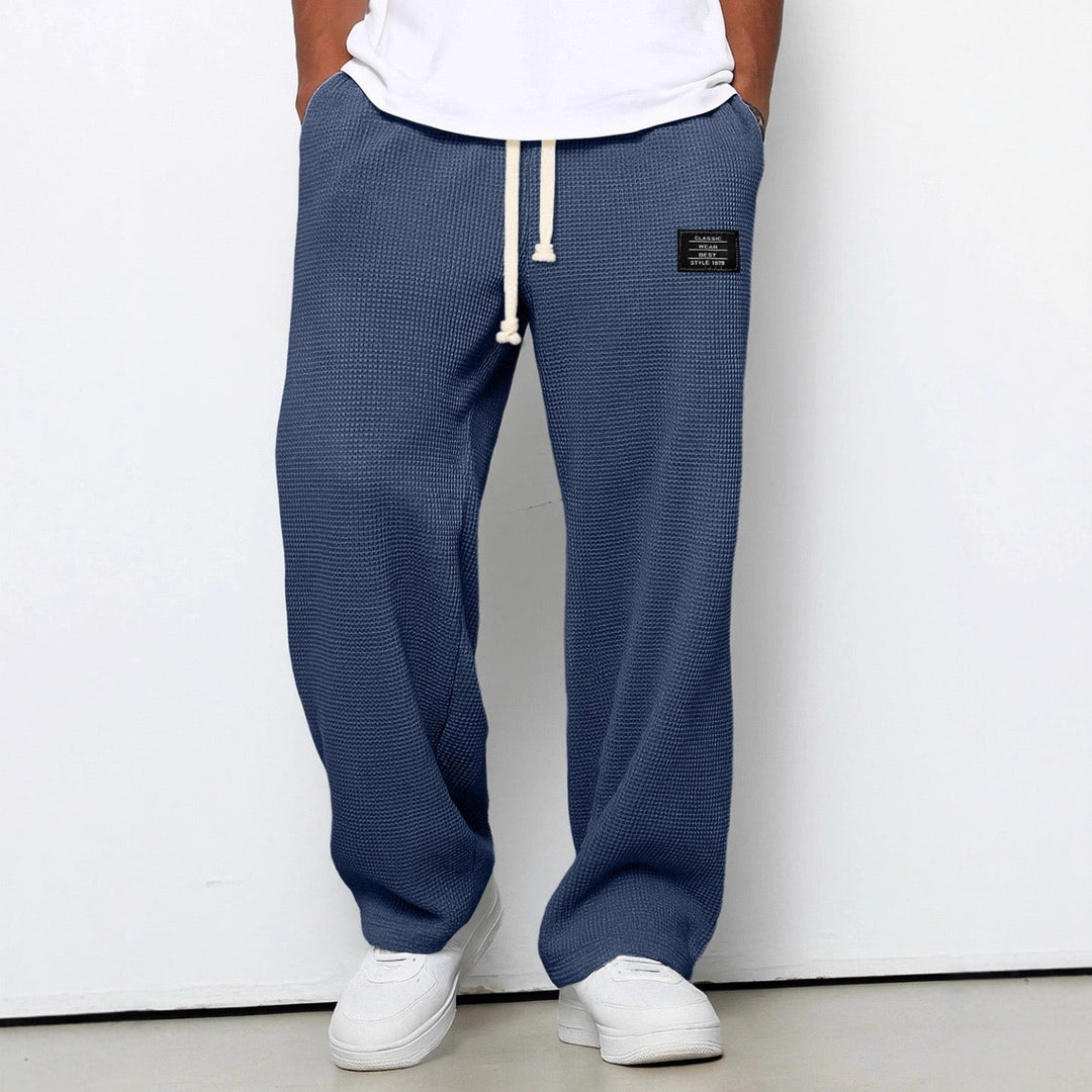 Men's wide leg textured trousers with drawstring waist, shown in blue and cream variants