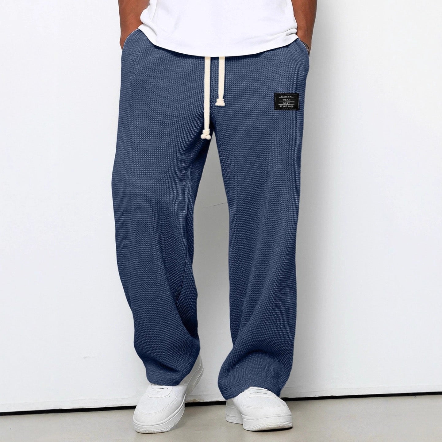 Men's wide leg textured trousers with drawstring waist, shown in blue and cream variants