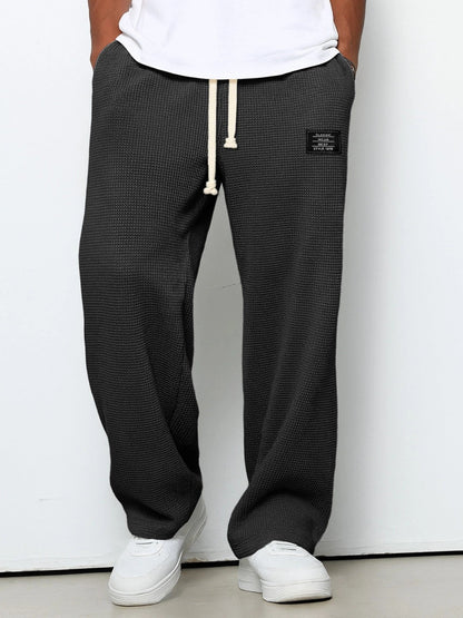 Men's wide leg textured trousers with drawstring waist, shown in blue and cream variants
