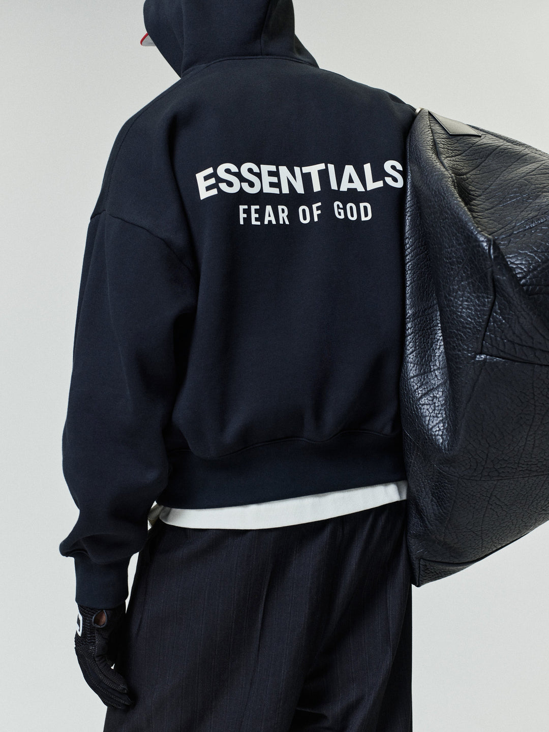 Black pullover hoodie with kangaroo pocket and back text graphic