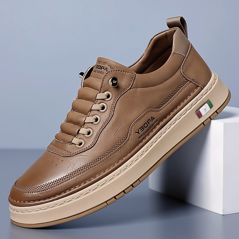 Low-top lace-up trainers with stitched panels and a contrast sole