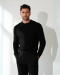 Men's black cable knit sweater with raised cable texture