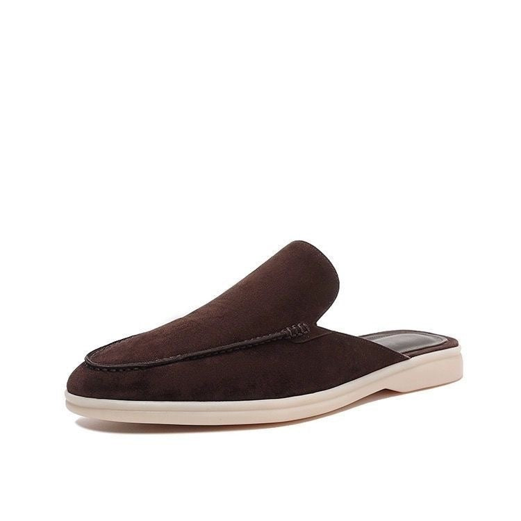 Black loafer mule with cream-coloured sole, shown from the side profile
