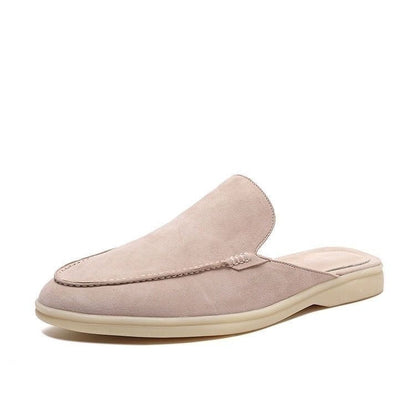 Black loafer mule with cream-coloured sole, shown from the side profile