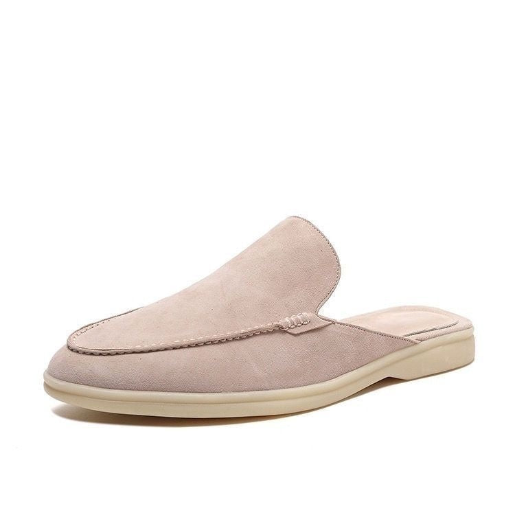 Black loafer mule with cream-coloured sole, shown from the side profile