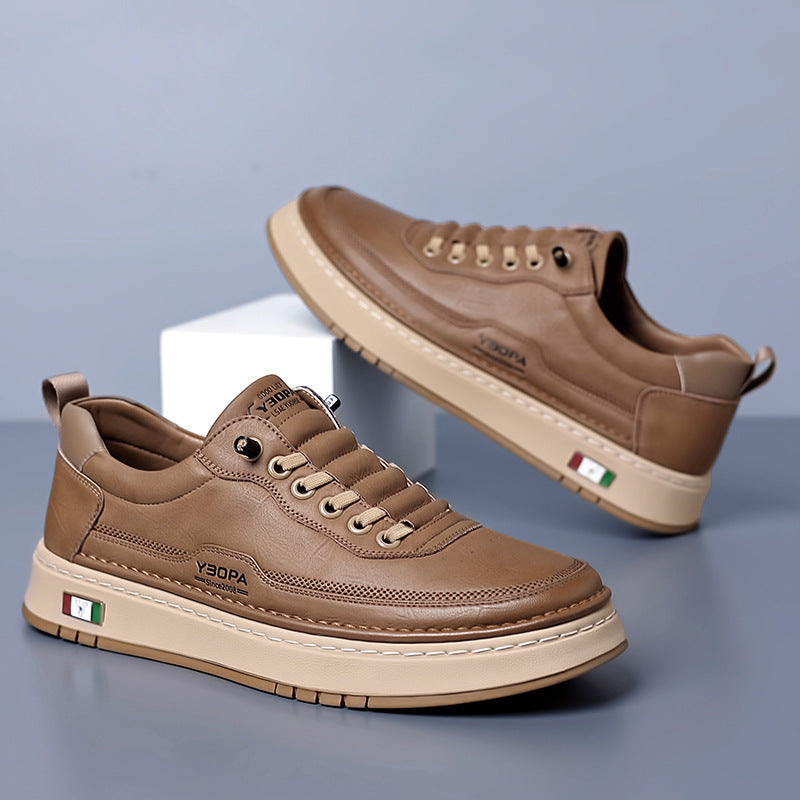 Low-top lace-up trainers with stitched panels and a contrast sole
