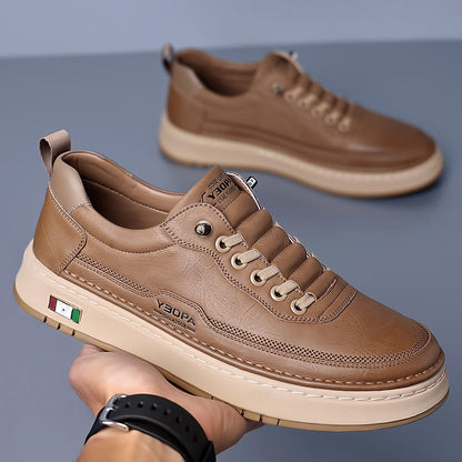 Low-top lace-up trainers with stitched panels and a contrast sole