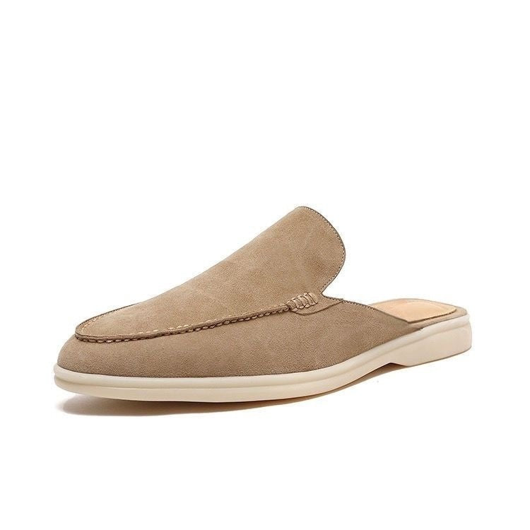 Black loafer mule with cream-coloured sole, shown from the side profile