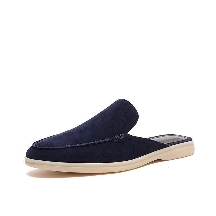 Black loafer mule with cream-coloured sole, shown from the side profile