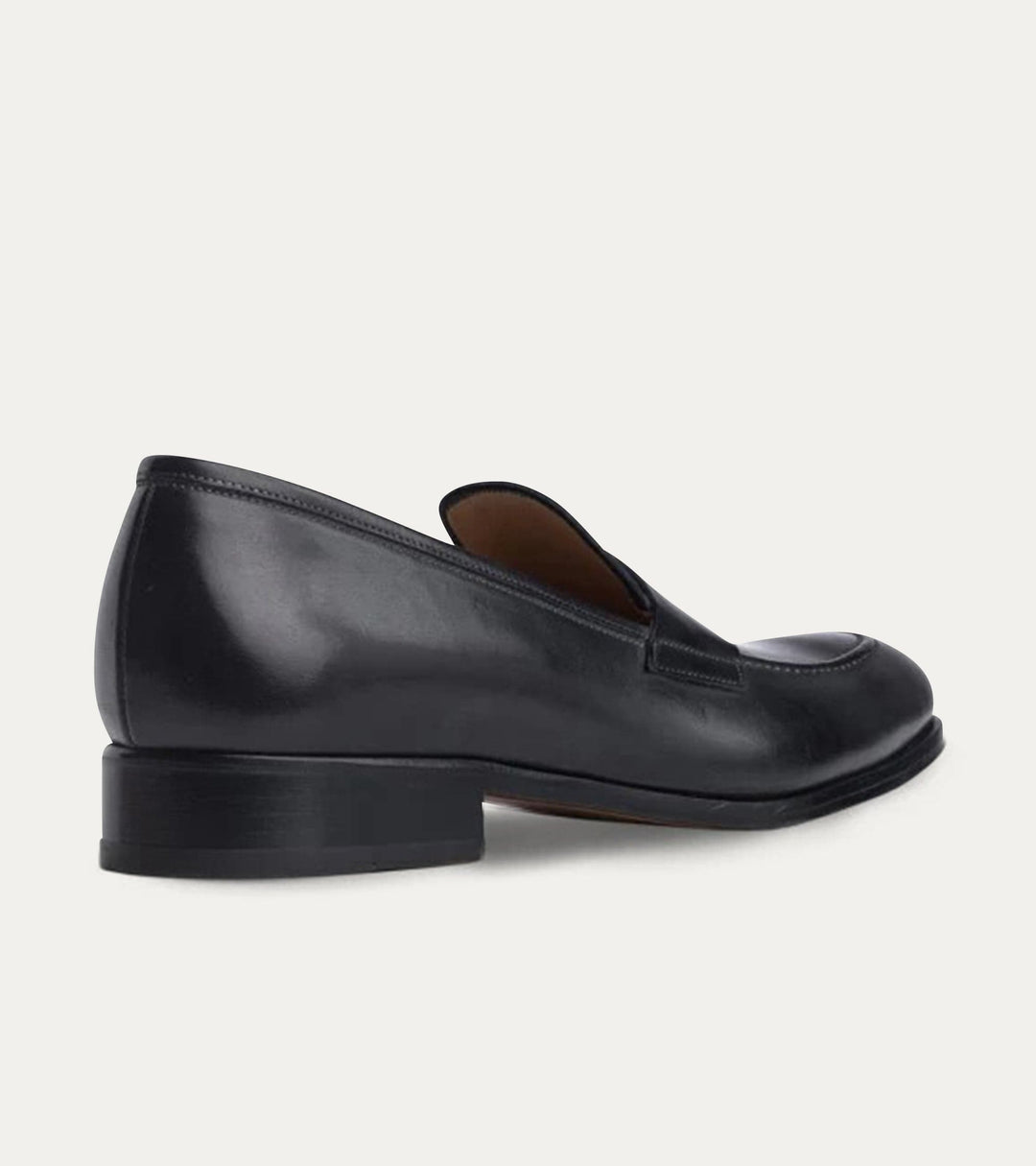 Black polished penny loafers with almond toes and low heels