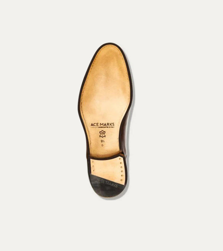 Black polished penny loafers with almond toes and low heels