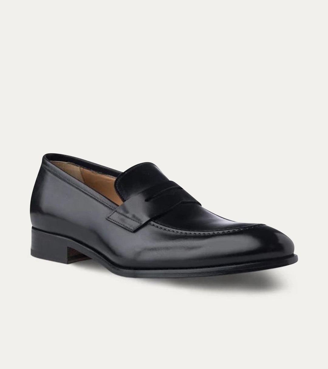 Black polished penny loafers with almond toes and low heels