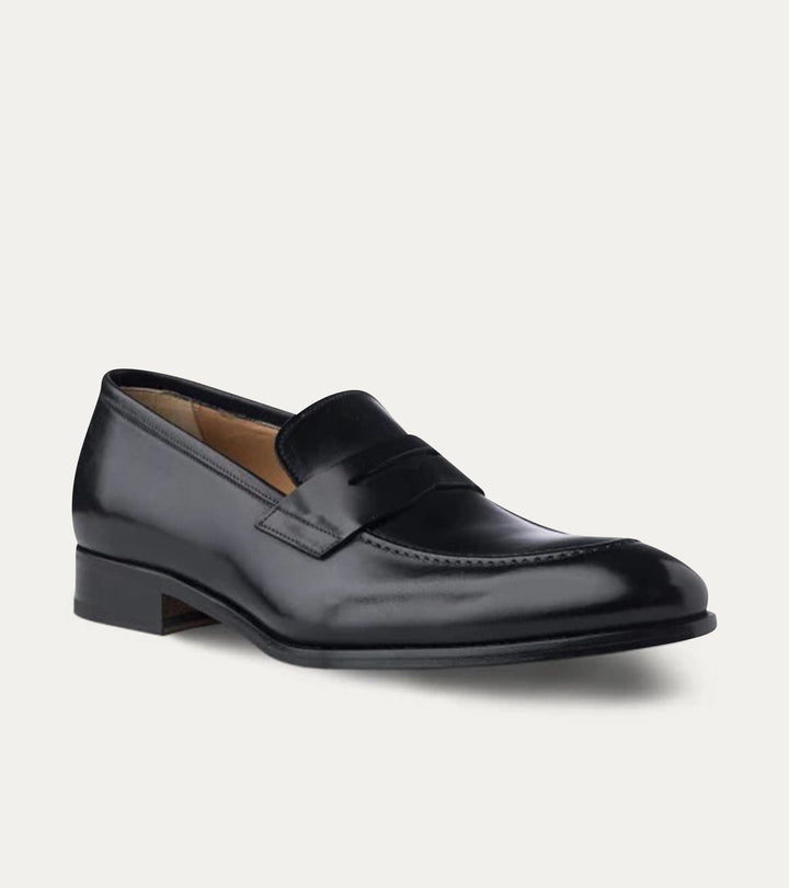 Black polished penny loafers with almond toes and low heels