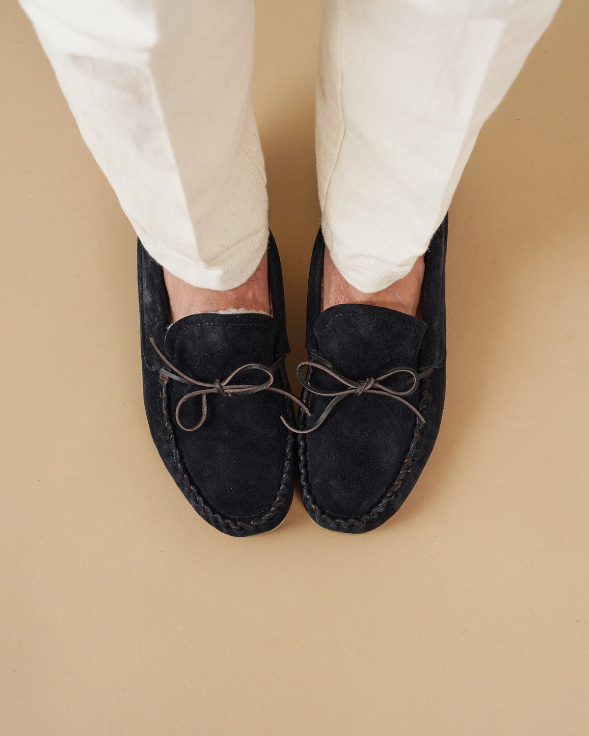 Men's navy suede moccasin loafers with lace detail and flat soles
