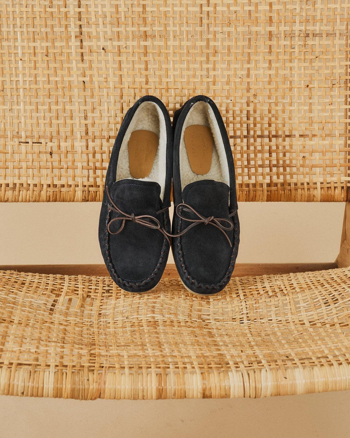 Men's navy suede moccasin loafers with lace detail and flat soles