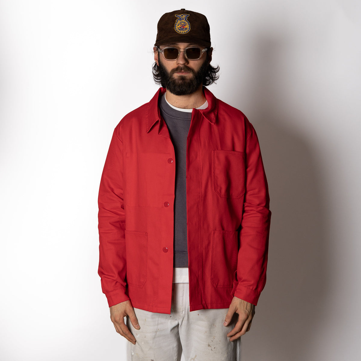 Men's red long-sleeve chore jacket with button front and three patch pockets